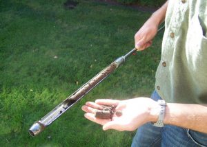 person taking a soil sample