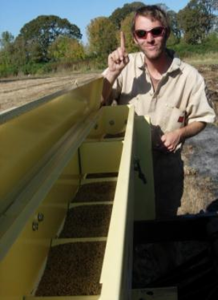 Photo of Chris Seal and a seed drill
