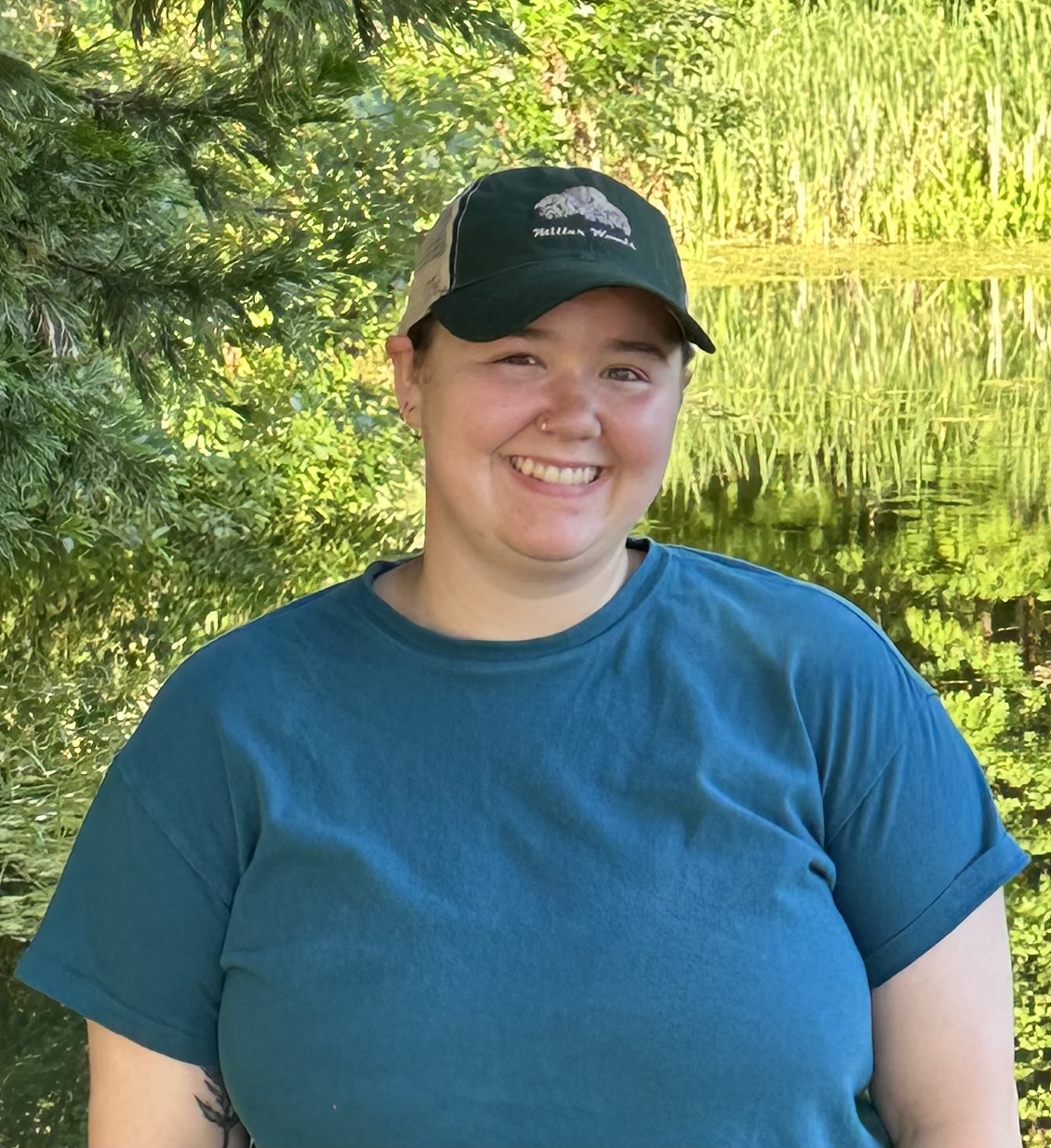Tabitha Chambers A photo of a person wearing a hat and a blue t-shirt.
